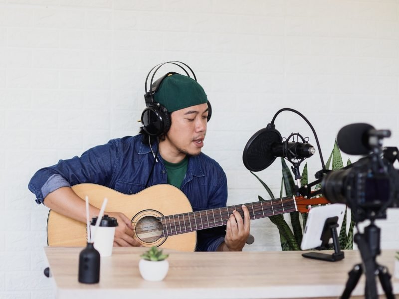 young-man-is-singing-and-play-guitar-on-music-podcast.jpg